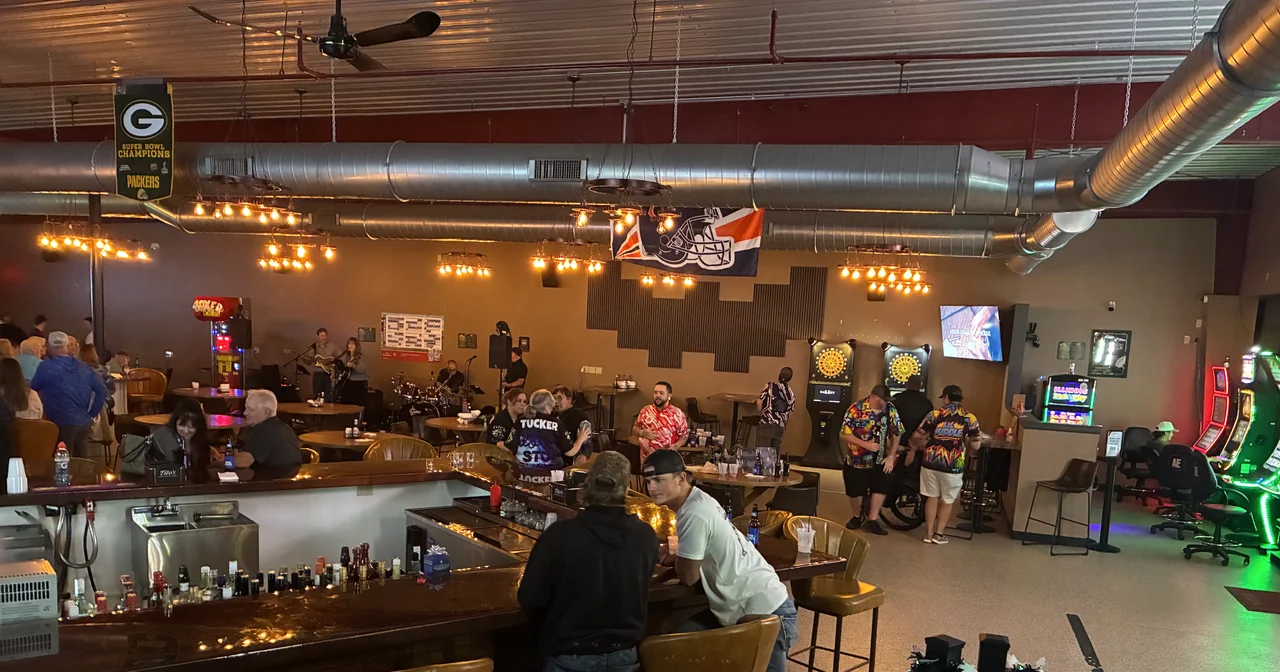 Guests gathering at the real Kings bar, with dartboards and live music in the dining room